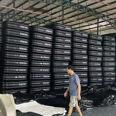 piles of air mattresses on warehouse